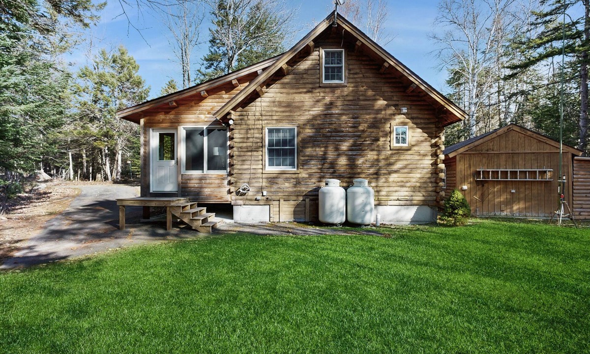Beaver Cove House | Cozy cabin with covered porch, firepit, grill, fireplace, & washer/dryer