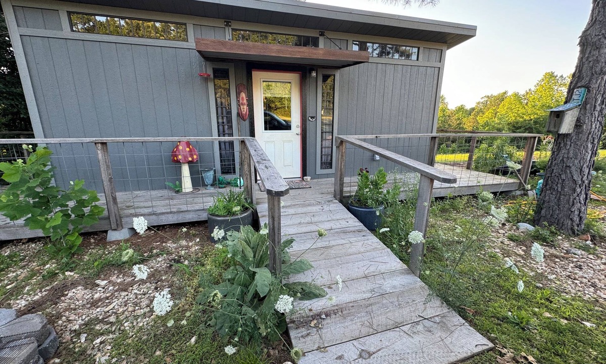 Pineville Cabin | The Ridge Adventure Center rustic pet friendly tiny cabin, outdoor shower stage