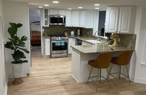 River Bottoms House | Beachy Home in Provo. Large deck with builtin hot tub, Fire pit, Palapa