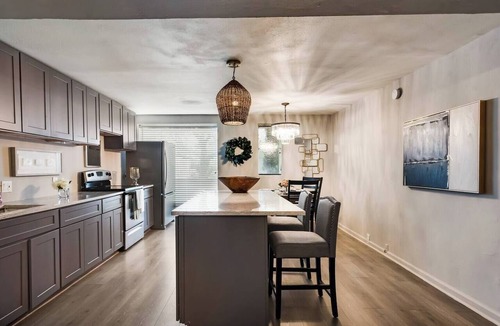 Old East Dallas Condo | 2BR/1.5BA furnished condo in Central Dallas with private patio and garden views. King + queen beds, modern kitchen, fast Wi-Fi, washer/dryer, gated parking. Resort courtyard with pool, sauna, cold plunge. Near Downtown.