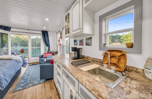 Brackney Boat Rental | Charming Tiny Houseboat Cozy Front Porch Literally on the Water!