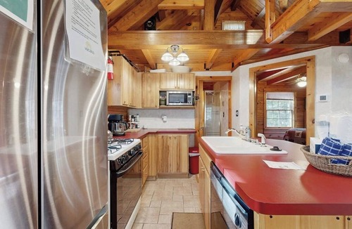 Beaver Cove House | Cozy cabin with covered porch, firepit, grill, fireplace, & washer/dryer