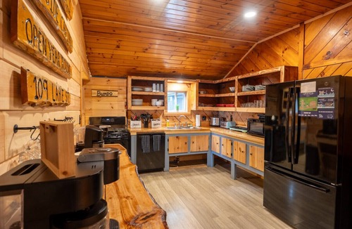 Northeast Somerset Cabin | Katahdin - Cabin 4 · Lawrence`s Lakeside Cabins | `Katahdin`: Boat Dock + Kayaks
