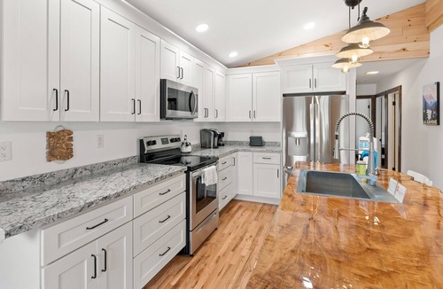 Silver Bay House | Lake-view home with large deck, grill, lawn, & mtn views - dog-friendly