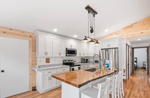 Silver Bay House | Lake-view home with large deck, grill, lawn, & mtn views - dog-friendly