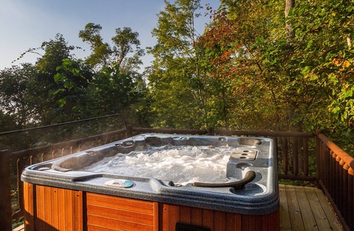Almond Cabin | Secluded log cabin with fireplace and hot tub on deck.