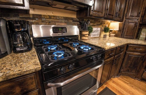 Hochatown Cabin | Soaring cathedral ceilings, gas rock fireplace, large hot tub, smart tv, games.
