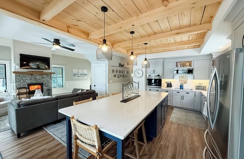 Ellsworth House | Stunning lakefront home with serene outside sitting area overlooking the water.