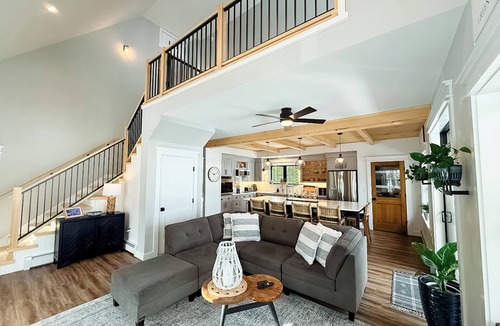 Ellsworth House | Stunning lakefront home with serene outside sitting area overlooking the water.