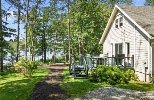 Warren House | Sunny, lakefront home on South Pond with private dock, great deck & firepit