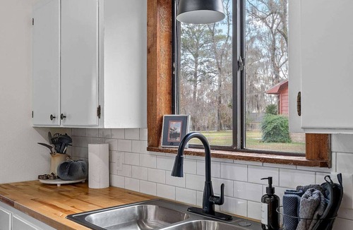Uncertain House | Warm, Rustic Lodge with private dock access directly across the street, featuring a firepit & picnic table for outdoor dining