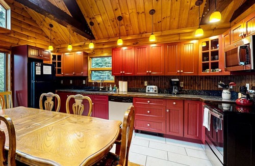 Greenville Cabin | Waterfront Cabin with Private Deck Loaded with Kayaks in Maine