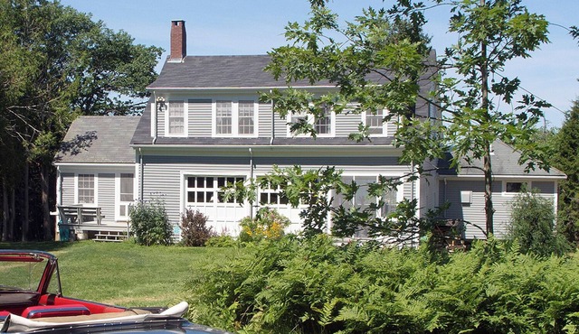 A unique two-story house on the waterfront with a big lawn and stunning views
