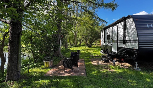 Cozy Riverfront RV with pool and playground in Cortland