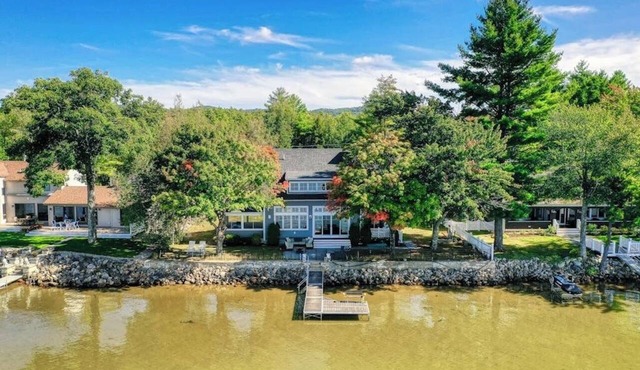 Dog-friendly lakefront home with lake views, firepit, dock, patio, & grill