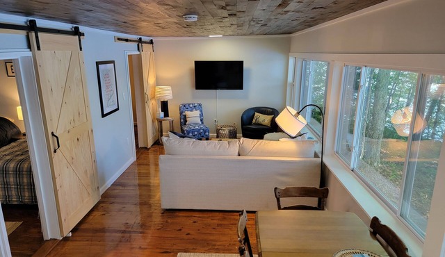Enjoy Lake life in this renovated Camp, 50 ft from water. Private dock, beach.