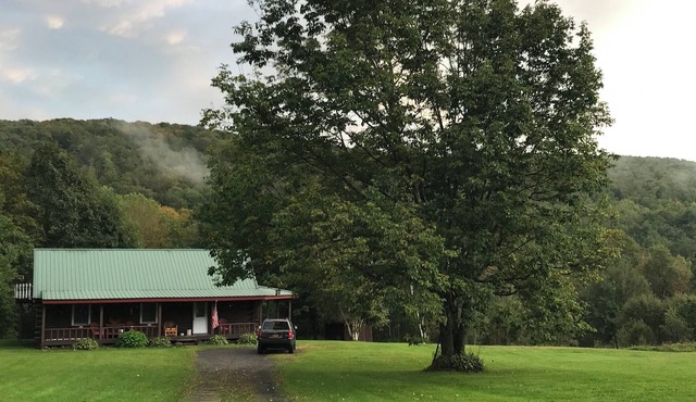 Escape to the country at our creek-side log cabin.