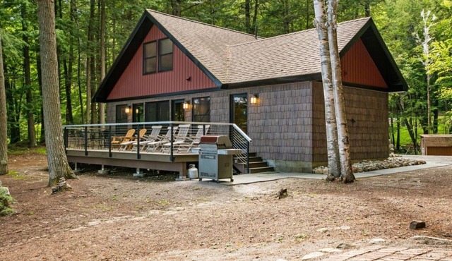 Lakefront home steps away from a private, gentle sloping sandy beach & fire pit.