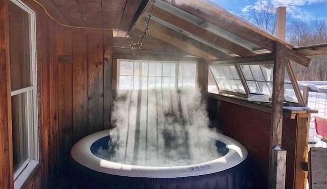 Rustic cabin w/29 acres. Hot tub, wood stove, nature trails, pet friendly &more