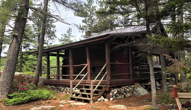 Small private Island on scenic Maine pond with charming authentic log cabin.