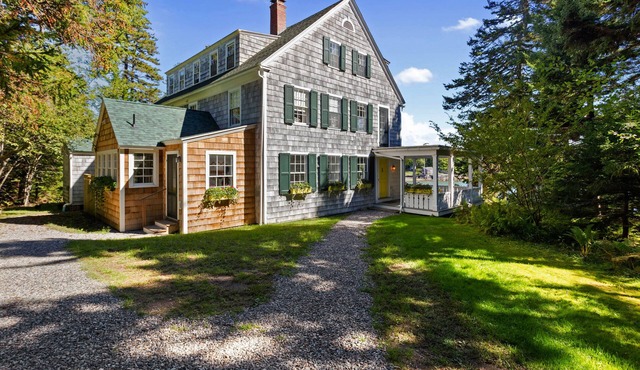 Summer cottage with spacious porch overlooking Gilpatrick Cove near Acadia.