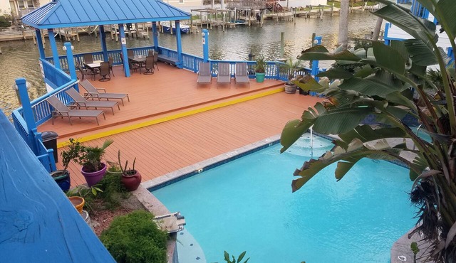 Waterfront Paradise has a Reserved Boat Slip, Overlooks the Pool & the Canal